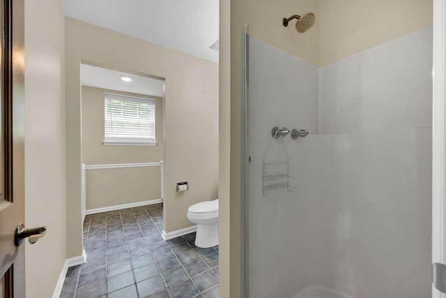 full bath with walk in shower, toilet, tile patterned floors, and baseboards