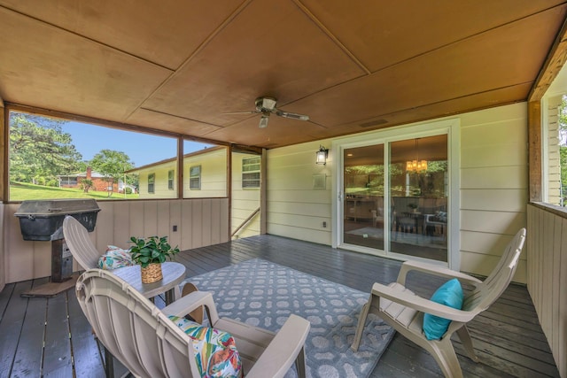 wooden deck with a ceiling fan