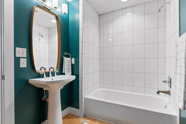 623 Hamilton Ave, Chattanooga, TN 37405 - bathroom with washtub / shower combination, wood finished floors, and baseboards