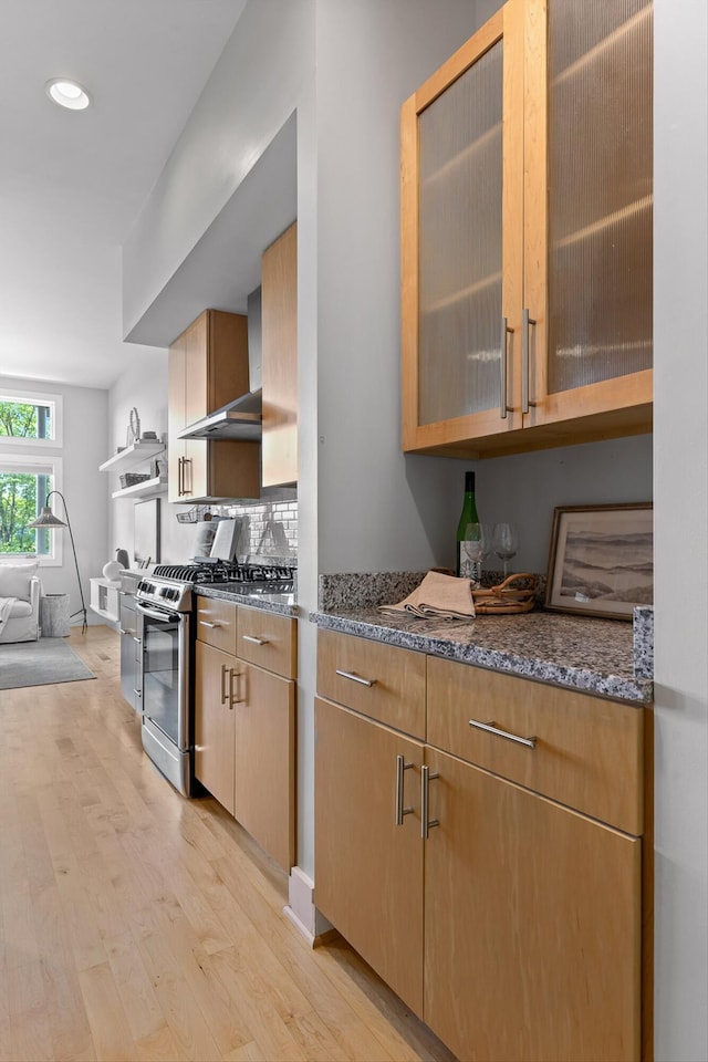 623 Hamilton Ave, Chattanooga, TN 37405 - kitchen with stainless steel range with gas cooktop, light wood-type flooring, dark stone countertops, glass insert cabinets, and recessed lighting