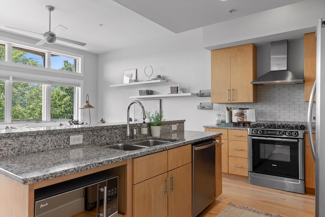 623 Hamilton Ave, Chattanooga, TN 37405 - kitchen featuring stainless steel appliances, wall chimney range hood, a sink, open shelves, and light wood finished floors