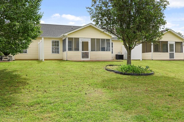 548 Flagstone Dr, Rossville, GA 30741 - back of property featuring a sunroom, a yard, cooling unit, and roof with shingles