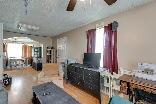 241 Bryant Ln, Tracy City, TN 37387 - living area featuring ceiling fan, arched walkways, a textured ceiling, and light wood-style floors