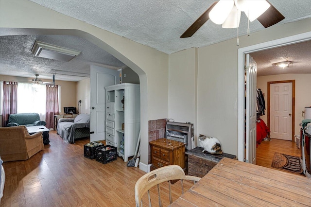 241 Bryant Ln, Tracy City, TN 37387 - dining room featuring a textured ceiling, wood finished floors, ceiling fan, and arched walkways