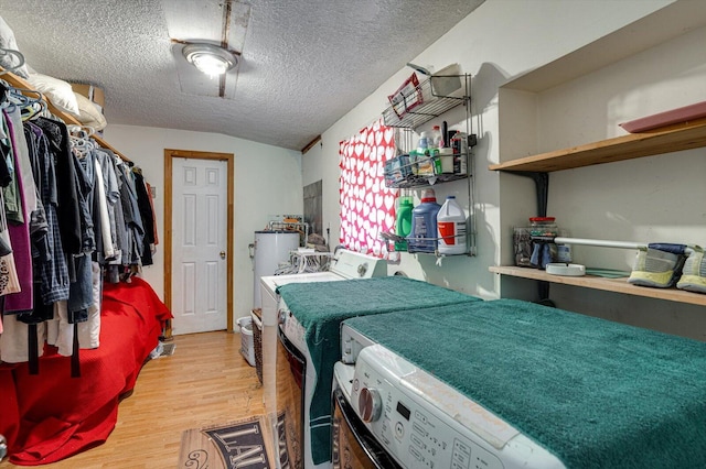 241 Bryant Ln, Tracy City, TN 37387 - washroom with washer and dryer, light wood finished floors, and a textured ceiling