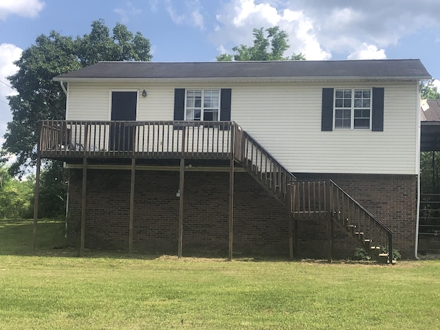 rear view of house featuring a yard, a deck, and stairs