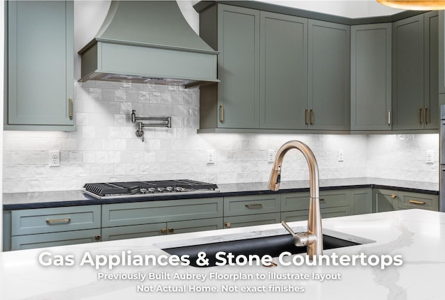4850 Amethyst Rd Unit 904, Chattanooga, TN 37419 - kitchen featuring premium range hood, stainless steel gas cooktop, backsplash, and light stone counters