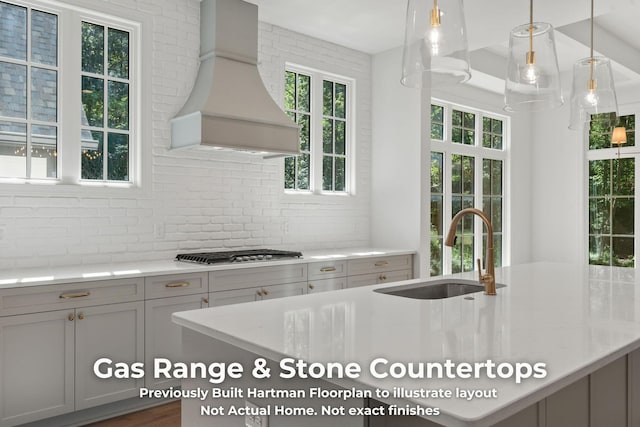 3070 Galena Cir Unit 830, Chattanooga, TN 37419 - kitchen with a sink, premium range hood, stainless steel gas stovetop, light stone counters, and gray cabinetry