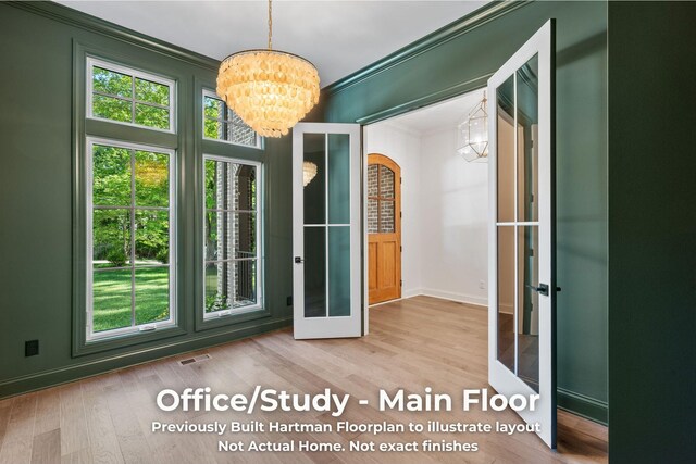 3070 Galena Cir Unit 830, Chattanooga, TN 37419 - doorway to outside with a chandelier, crown molding, plenty of natural light, wood finished floors, and baseboards