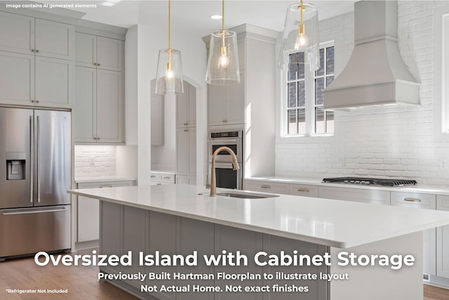 3070 Galena Cir Unit 830, Chattanooga, TN 37419 - kitchen with appliances with stainless steel finishes, custom range hood, backsplash, a kitchen island with sink, and pendant lighting