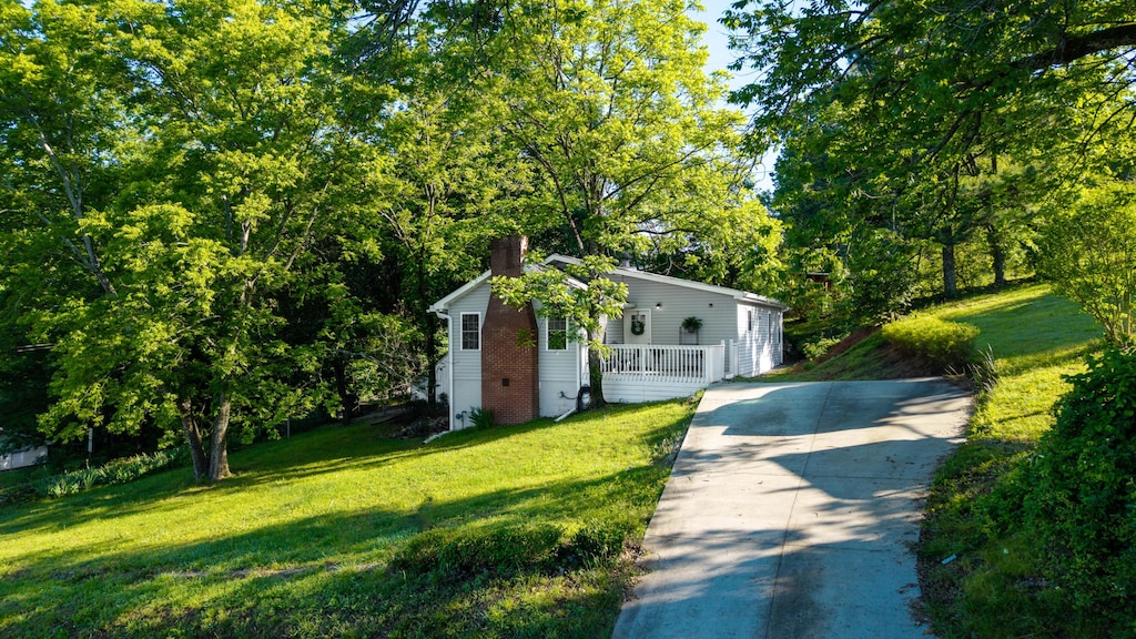 818 Dunlap Ave, Chattanooga, TN 37412 - view of front of house with a chimney, a front lawn, and concrete driveway