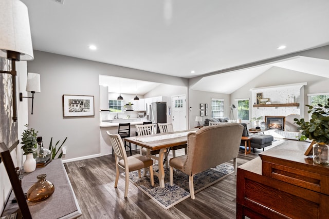 818 Dunlap Ave, Chattanooga, TN 37412 - dining area featuring a fireplace, dark wood finished floors, lofted ceiling, recessed lighting, and baseboards