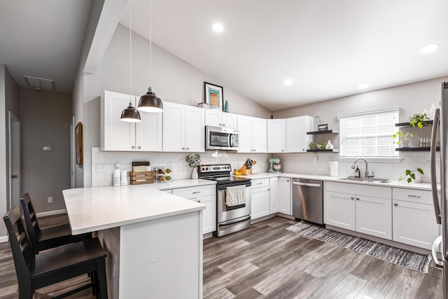818 Dunlap Ave, Chattanooga, TN 37412 - kitchen with appliances with stainless steel finishes, a sink, open shelves, a peninsula, and light countertops