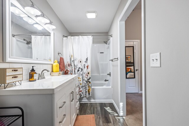 818 Dunlap Ave, Chattanooga, TN 37412 - full bathroom featuring vanity, shower / bath combo with shower curtain, baseboards, wood finished floors, and tasteful backsplash
