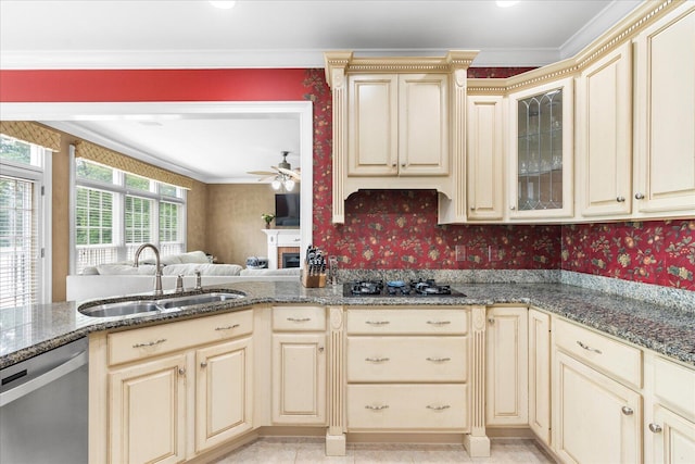 kitchen featuring cream cabinetry, a sink, stainless steel dishwasher, wallpapered walls, and black gas cooktop