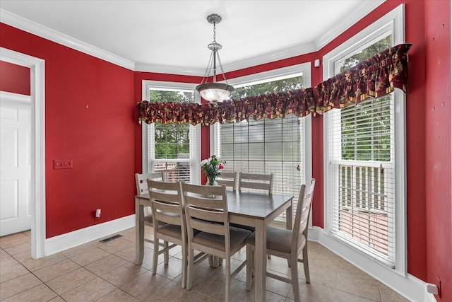 dining space featuring light tile patterned flooring, baseboards, and crown molding