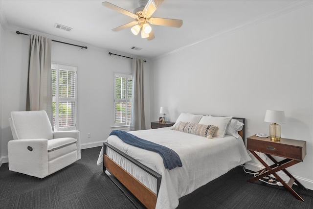 bedroom with dark colored carpet, baseboards, crown molding, and ceiling fan