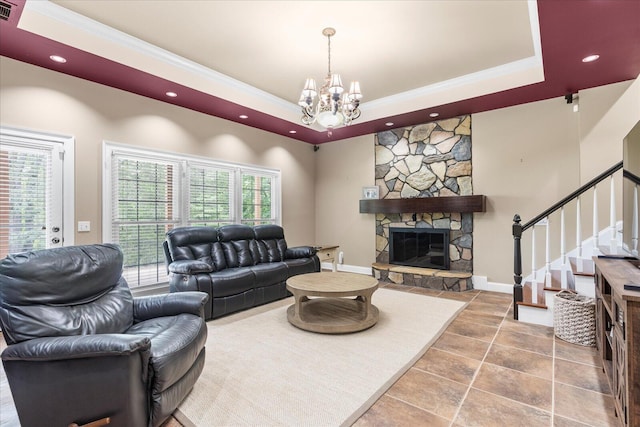 living area featuring a fireplace, a tray ceiling, stairs, a chandelier, and recessed lighting