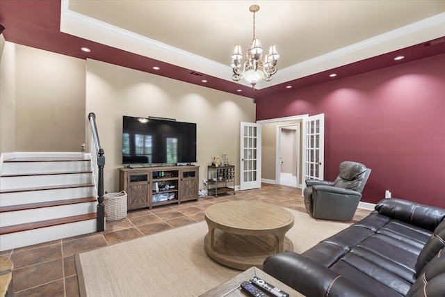 living room featuring a raised ceiling, french doors, a chandelier, recessed lighting, and ornamental molding