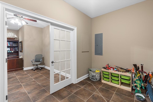 playroom featuring electric panel, baseboards, dark tile patterned flooring, and a ceiling fan