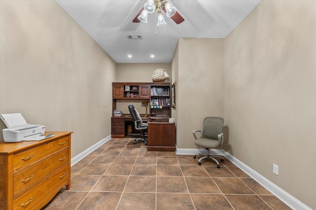 office space featuring ceiling fan, baseboards, and dark tile patterned flooring