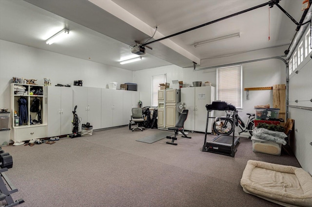 exercise area featuring a garage and carpet