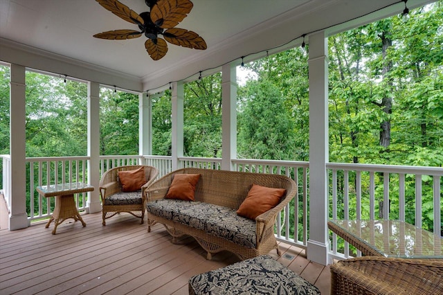 sunroom featuring ceiling fan and healthy amount of natural light