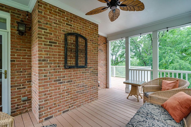 sunroom featuring ceiling fan and plenty of natural light