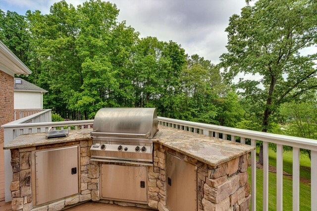 view of patio / terrace featuring area for grilling and view of scattered trees