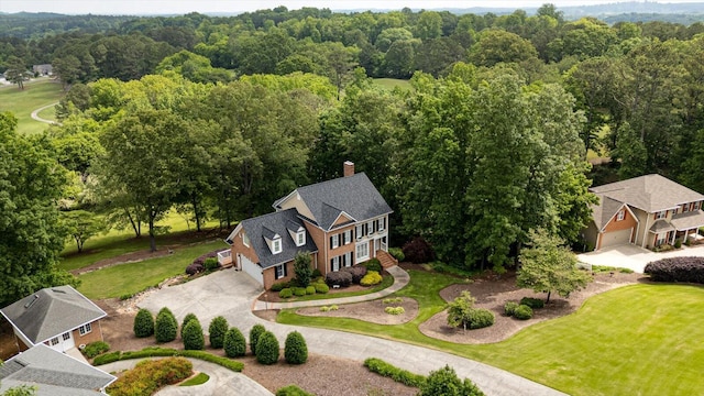 view from above of property with a heavily wooded area