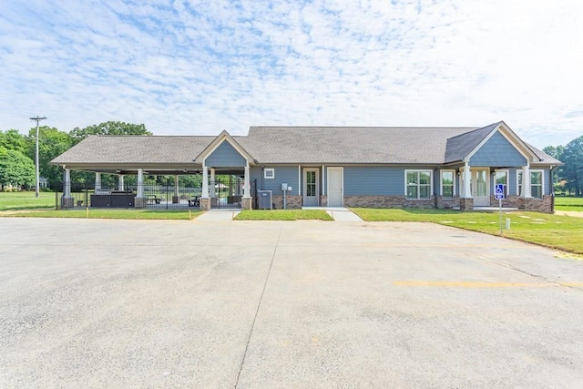 single story home featuring a front lawn and central air condition unit