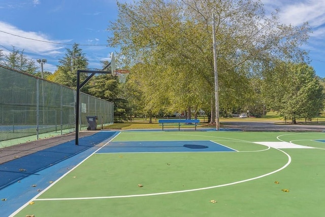 view of basketball court with community basketball court and fence