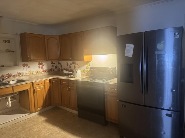 111 Arlington Ter, Chattanooga, TN 37410 - kitchen with black fridge, stove, light countertops, a sink, and crown molding