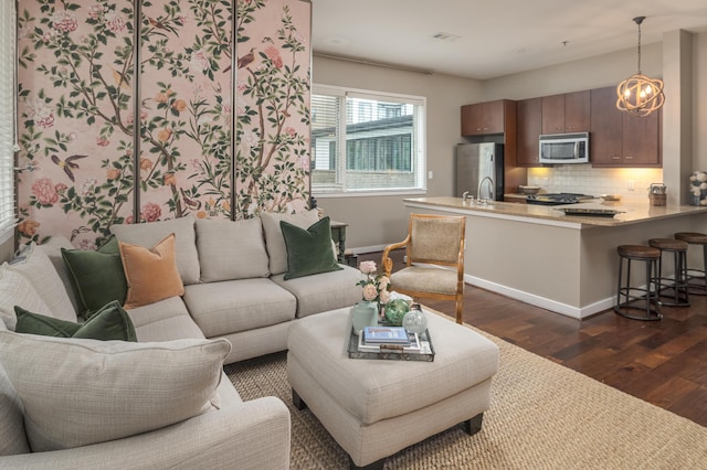200 Manufacturers Rd Apt 339, Chattanooga, TN 37405 - living room featuring dark wood-type flooring, baseboards, and a chandelier