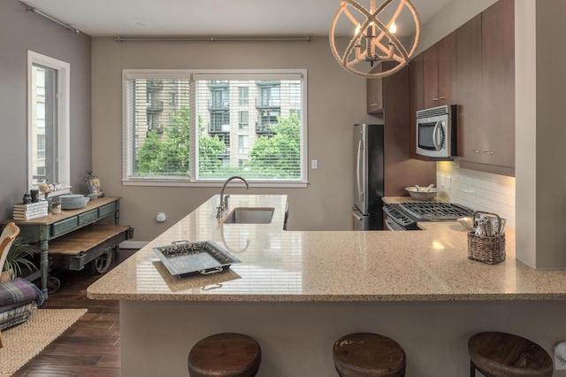 200 Manufacturers Rd Apt 339, Chattanooga, TN 37405 - kitchen with stainless steel appliances, a sink, a breakfast bar, tasteful backsplash, and plenty of natural light
