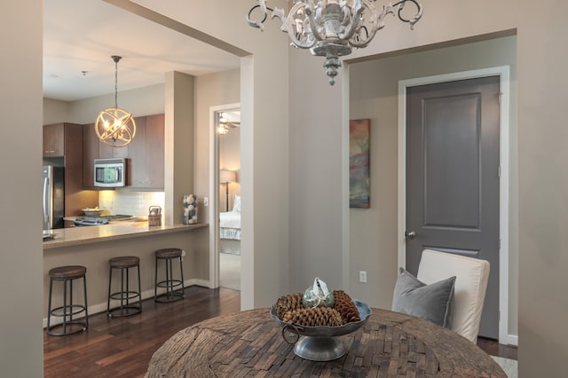 200 Manufacturers Rd Apt 339, Chattanooga, TN 37405 - dining room with a chandelier, dark wood-type flooring, and baseboards