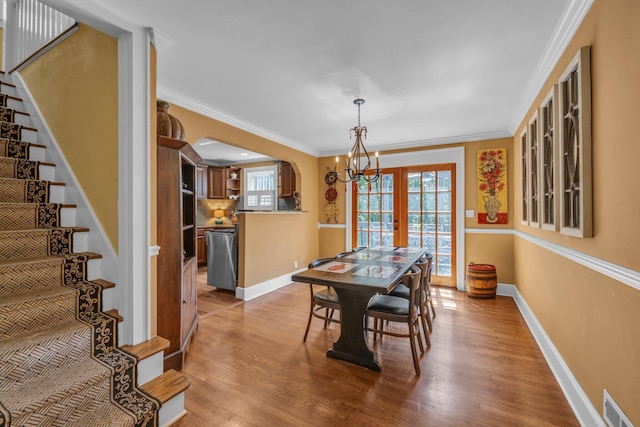 122 Hilltop Dr, Chattanooga, TN 37411 - dining room featuring healthy amount of natural light, a chandelier, wood finished floors, and crown molding