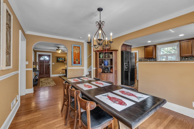 122 Hilltop Dr, Chattanooga, TN 37411 - dining space with arched walkways, light wood-type flooring, a chandelier, a ceiling fan, and ornamental molding