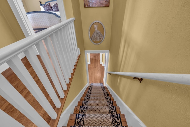 122 Hilltop Dr, Chattanooga, TN 37411 - stairway with baseboards, a towering ceiling, a textured wall, and wood finished floors