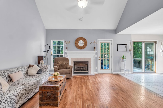 8369 Shadetree Ln, Ooltewah, TN 37363 - living area featuring ceiling fan, a tiled fireplace, plenty of natural light, hardwood / wood-style flooring, and high vaulted ceiling