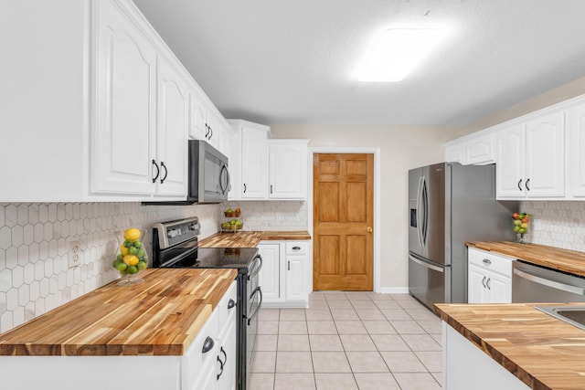 8369 Shadetree Ln, Ooltewah, TN 37363 - kitchen featuring wooden counters, stainless steel appliances, tasteful backsplash, light tile patterned floors, and white cabinets