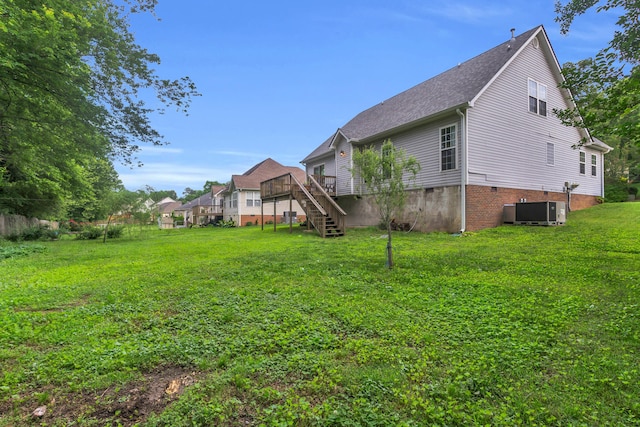 8369 Shadetree Ln, Ooltewah, TN 37363 - view of grassy yard featuring stairway, a wooden deck, and central AC