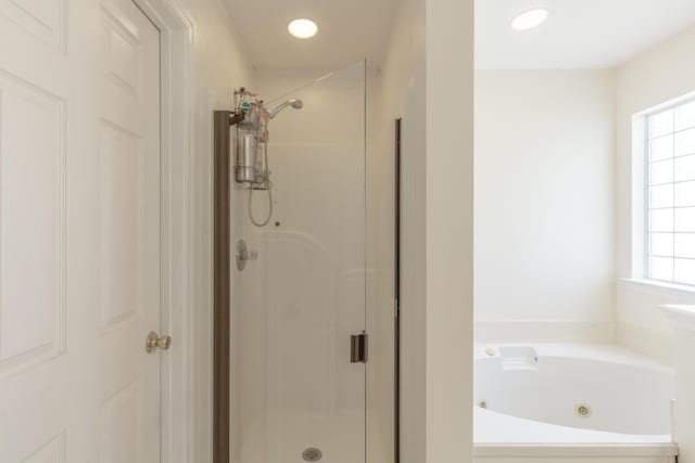 8369 Shadetree Ln, Ooltewah, TN 37363 - bathroom featuring a shower stall, healthy amount of natural light, and a tub with jets