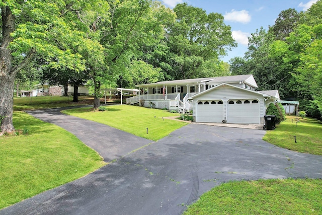 view of front of house with a porch, a front yard, asphalt driveway, and a garage