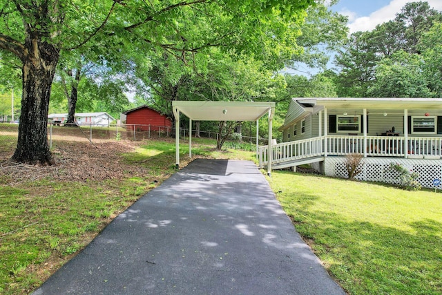 view of property's community featuring driveway and a carport