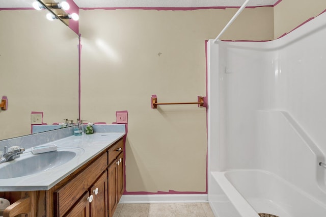 full bathroom with tile patterned floors, vanity, baseboards, and shower / bathtub combination