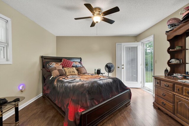bedroom featuring access to outside, dark wood-style flooring, a textured ceiling, baseboards, and a ceiling fan