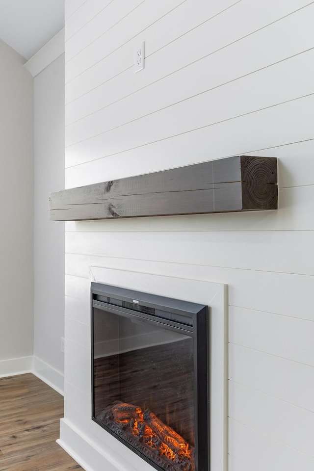 2508 Maple St, Chattanooga, TN 37406 - detailed view of a glass covered fireplace, wood finished floors, and baseboards