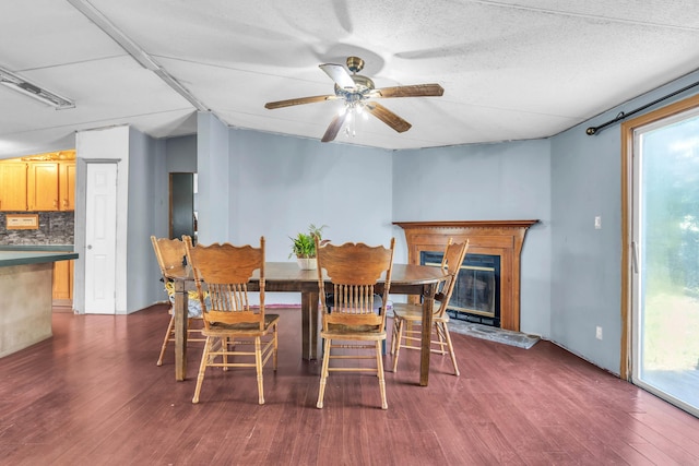 3250 Rolling Meadows Rd NW, Dalton, GA 30721 - dining space with dark wood-style floors, a ceiling fan, and a glass covered fireplace