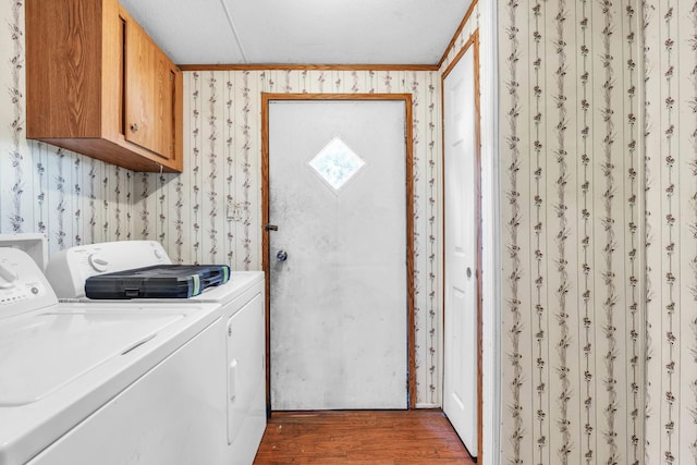 3250 Rolling Meadows Rd NW, Dalton, GA 30721 - washroom featuring washing machine and clothes dryer, wallpapered walls, wood finished floors, and cabinet space